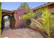 Private courtyard entrance featuring desert landscaping and stonework with an iron gate, offering a tranquil outdoor space at 7204 Royal Melbourne Dr, Las Vegas, NV 89131