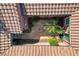 Aerial view of a private courtyard with a desert garden surrounded by the home's terracotta-tiled roof at 7204 Royal Melbourne Dr, Las Vegas, NV 89131