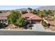 Charming single-story home featuring a tile roof, desert landscaping, and an attached two-car garage at 7204 Royal Melbourne Dr, Las Vegas, NV 89131