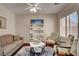 Cozy living room featuring a sofa, chairs, and stylish bookshelf at 7204 Royal Melbourne Dr, Las Vegas, NV 89131