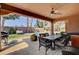 Outdoor patio featuring a fireplace, dining set, and comfortable seating area at 7204 Royal Melbourne Dr, Las Vegas, NV 89131