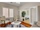 Comfortable sitting area featuring stylish chairs, hardwood floors, plantation shutters, and an adjacent office, offering quiet space at 7204 Royal Melbourne Dr, Las Vegas, NV 89131