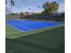 Bright blue community tennis court with green accents is ready for a game! at 7204 Royal Melbourne Dr, Las Vegas, NV 89131