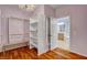 Spacious walk-in closet with shelving, a mirror, and a doorway to bathroom at 7204 Royal Melbourne Dr, Las Vegas, NV 89131