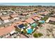 An aerial view of a desert community featuring terra cotta roofs, desert landscaping, and private pools at 7489 Crystal Clear Ave, Las Vegas, NV 89113