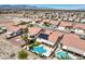 An aerial view of a desert community featuring terra cotta roofs, desert landscaping, and private pools at 7489 Crystal Clear Ave, Las Vegas, NV 89113