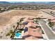 An aerial view of a desert community with terra cotta roofs, desert landscaping, and private pools at 7489 Crystal Clear Ave, Las Vegas, NV 89113