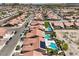 An aerial view of a desert community featuring terra cotta roofs, desert landscaping, and private pools at 7489 Crystal Clear Ave, Las Vegas, NV 89113