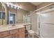 Well-lit bathroom featuring a large vanity mirror and shower with sliding glass doors at 7489 Crystal Clear Ave, Las Vegas, NV 89113