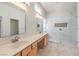 Modern bathroom featuring double sinks, quartz counters and walk-in shower with tile at 7489 Crystal Clear Ave, Las Vegas, NV 89113