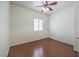 Bedroom with wood floors, ceiling fan, neutral paint and shuttered window at 7489 Crystal Clear Ave, Las Vegas, NV 89113