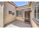 Covered entryway showcasing decorative wall art, a front door, and a large window at 7489 Crystal Clear Ave, Las Vegas, NV 89113