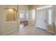 Inviting entryway with tiled floors, a white door, and a view into a living space at 7489 Crystal Clear Ave, Las Vegas, NV 89113