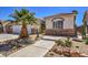 Charming single-story home with desert landscaping featuring cacti and a small tree at 7489 Crystal Clear Ave, Las Vegas, NV 89113