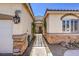 Front entrance featuring an iron gate and arched trellis between the house and garage at 7489 Crystal Clear Ave, Las Vegas, NV 89113