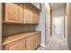 View of hallway featuring tile floor, neutral paint and wooden cabinets for storage at 7489 Crystal Clear Ave, Las Vegas, NV 89113