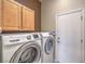 Modern laundry room includes Samsung washer and dryer and overhead cabinet space at 7489 Crystal Clear Ave, Las Vegas, NV 89113