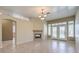 Spacious living room offers fireplace, tile flooring and entrance to the kitchen at 7489 Crystal Clear Ave, Las Vegas, NV 89113