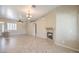 Inviting living room with fireplace, tile flooring, and views of the backyard at 7489 Crystal Clear Ave, Las Vegas, NV 89113