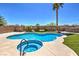 Beautiful backyard pool and spa, with stone wall and mature landscaping for privacy at 7489 Crystal Clear Ave, Las Vegas, NV 89113