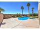 Stunning pool area features tall palm trees, a stone perimeter wall, and a custom in-ground pool at 7489 Crystal Clear Ave, Las Vegas, NV 89113