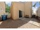 A cozy backyard featuring a sliding glass door, paved area, gravel, and limited bench seating at 7589 Grassy Bank St, Las Vegas, NV 89139