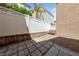 Cozy backyard featuring stone pavers, gravel area, bench and block fence at 7589 Grassy Bank St, Las Vegas, NV 89139