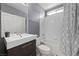 Bathroom featuring a modern vanity, white tile, and shower-tub combo at 7589 Grassy Bank St, Las Vegas, NV 89139