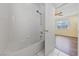 This bathroom features a shower and tub combination with white tile at 7589 Grassy Bank St, Las Vegas, NV 89139