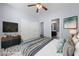 Bright bedroom featuring a fan, decorative flooring, and closet storage at 7589 Grassy Bank St, Las Vegas, NV 89139
