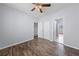 This bright bedroom features wood floors, a ceiling fan, and easy access to a closet at 7589 Grassy Bank St, Las Vegas, NV 89139