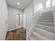 Hallway with wood flooring, leading to the bathroom and staircase at 7589 Grassy Bank St, Las Vegas, NV 89139