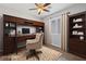 Elegant home office with custom wood desk, cabinets and bookshelves, plus a plush chair and decorative rug at 7589 Grassy Bank St, Las Vegas, NV 89139