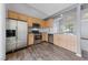 Modern kitchen featuring stainless steel appliances and wood-look flooring at 7589 Grassy Bank St, Las Vegas, NV 89139