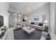 Staged living room with vaulted ceilings, modern lighting and plush furnishings at 7589 Grassy Bank St, Las Vegas, NV 89139