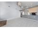 Open-concept living area with vaulted ceilings seamlessly connecting to the kitchen at 7589 Grassy Bank St, Las Vegas, NV 89139