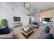 Bright living room with high ceilings, modern furnishings, and an open concept kitchen at 7589 Grassy Bank St, Las Vegas, NV 89139