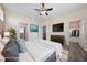 Spacious main bedroom with wood floors, large TV and views into the bedroom's closet and bathroom at 7589 Grassy Bank St, Las Vegas, NV 89139