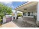 A covered outdoor patio featuring a stainless steel grill and ceiling fan at 7589 Grassy Bank St, Las Vegas, NV 89139