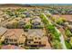 Back aerial view of the home showcasing the backyard, neighboring houses, and adjacent green space at 7931 Campers Village Ave, Las Vegas, NV 89178