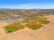 Aerial view of baseball park fields with dirt roads along the perimeter and desert landscape in the background at 7931 Campers Village Ave, Las Vegas, NV 89178