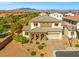 An aerial view of a home showcasing the rooftop with a stunning desert mountain view in the background at 7931 Campers Village Ave, Las Vegas, NV 89178