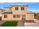 Exterior view of home showcasing backyard with brick patio, artificial turf and low maintenance landscaping at 7931 Campers Village Ave, Las Vegas, NV 89178