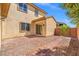 Enjoy the backyard with a brick patio, desert landscaping, and easy access through a sliding glass door at 7931 Campers Village Ave, Las Vegas, NV 89178