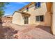 Backyard with brick patio, xeriscaping, and a sliding glass door leading indoors for easy outdoor access at 7931 Campers Village Ave, Las Vegas, NV 89178