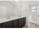 Bathroom featuring a large vanity with dual sinks and a shower-tub combo at 7931 Campers Village Ave, Las Vegas, NV 89178