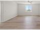Bedroom featuring a large window, modern flooring, and ample space at 7931 Campers Village Ave, Las Vegas, NV 89178