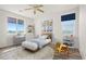 Bright bedroom with hardwood floors, modern decor, and a large window for natural light at 7931 Campers Village Ave, Las Vegas, NV 89178