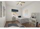 A cozy bedroom with a comfortable bed, a vanity, and decorative wall art, lit by a ceiling fan at 7931 Campers Village Ave, Las Vegas, NV 89178