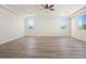Bonus room with tray ceiling, recessed lighting, wood flooring, and multiple windows at 7931 Campers Village Ave, Las Vegas, NV 89178